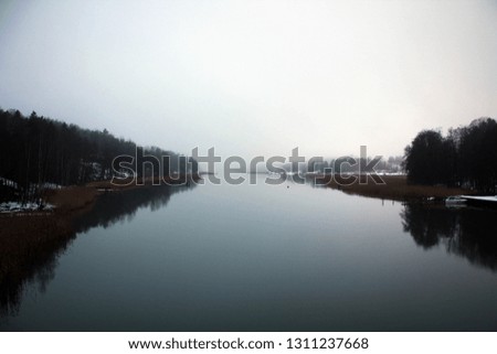 Scenic misty landscape of winter river not far from Turku, Finland