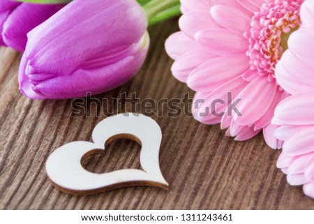 Tulips and gerbera flowers with heart close up