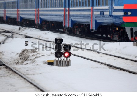 railway traffic light on the background of a modern train. fast train at the railway station, will take to any part of the world. travel on different transport. the safety of the road.the stop signal