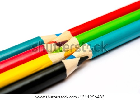 Seven colored pencils. The colors red, green, blue, cyan, magenta, yellow and black. Concept of color profiles converting from RGB to CMYK.