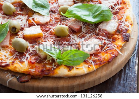 pizza with tomatoes and bacon, closeup