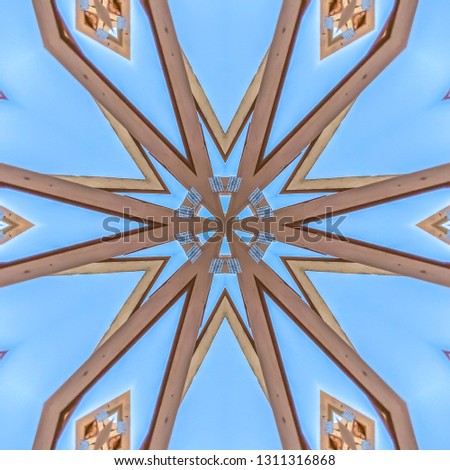 Wooden beams made into an arabesque design. Geometric kaleidoscope pattern on mirrored axis of symmetry reflection. Colorful shapes as a wallpaper for advertising background or backdrop.
