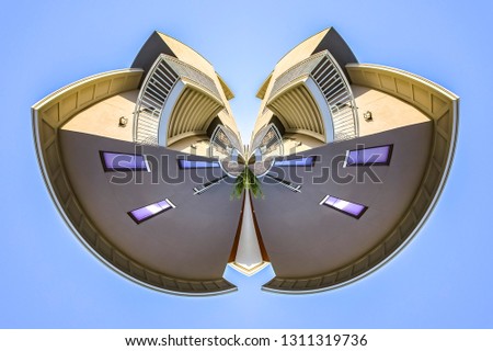 Dual radial bend of an apartment building. Geometric kaleidoscope pattern on mirrored axis of symmetry reflection. Colorful shapes as a wallpaper for advertising background or backdrop.