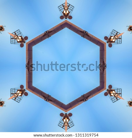 Decorative metal abstract shapes in a circle. Geometric kaleidoscope pattern on mirrored axis of symmetry reflection. Colorful shapes as a wallpaper for advertising background or backdrop.