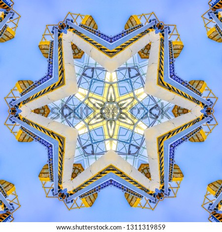 Cherry picker on construction site in the day. Geometric kaleidoscope pattern on mirrored axis of symmetry reflection. Colorful shapes as a wallpaper for advertising background or backdrop.