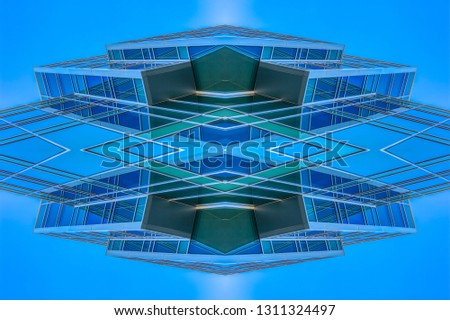 Angular building looking abstract with sky reflect. Geometric kaleidoscope pattern on mirrored axis of symmetry reflection. Colorful shapes as a wallpaper for advertising background or backdrop.