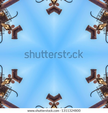 Abstract angular shapes made from metal bars. Geometric kaleidoscope pattern on mirrored axis of symmetry reflection. Colorful shapes as a wallpaper for advertising background or backdrop.