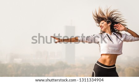 Zumba dance fitness instructor doing sport aerobic exercises. Motivational coach. Outdoor training