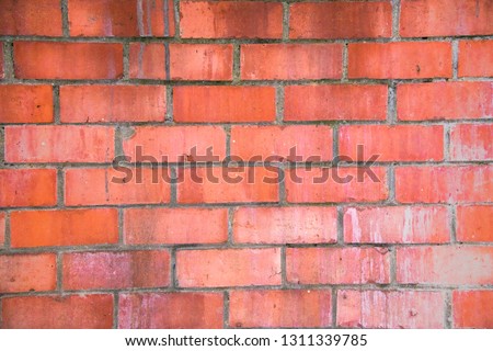 Old red brick wall surface.Texture, background.Roughly textured brick walls.Cement seams
