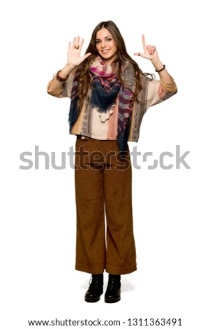 Full-length shot of Young hippie woman counting seven with fingers on isolated white background