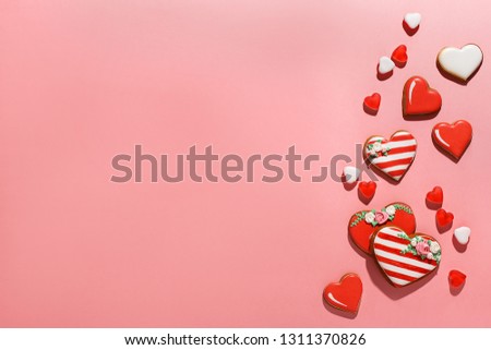 Set of various heart shaped decorated gingerbread cookies and heart shaped jelly on pink background. Overhead view, copy space. Valentine's Day concept
