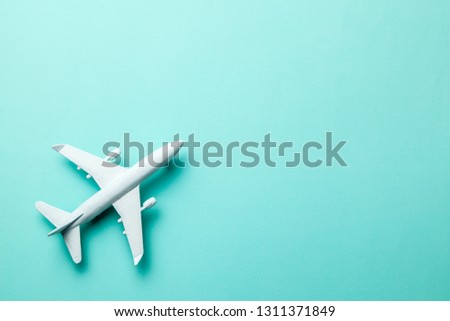 White passenger plane on green mint background. Copy space for text