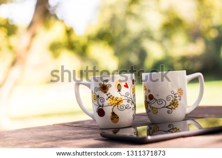 Two Cups and sunny trees