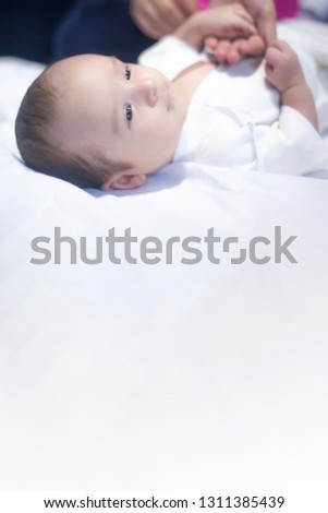 Vetical view to newborn boy with copy space on the bottom