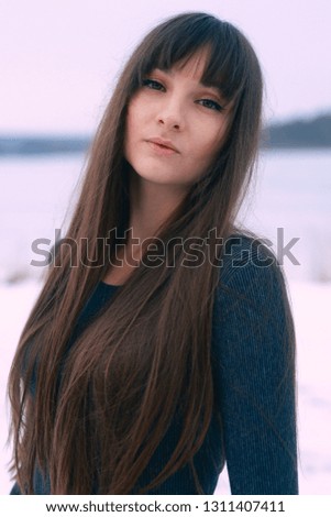 Pretty girl outdoor winter portrait on the ice lake 
