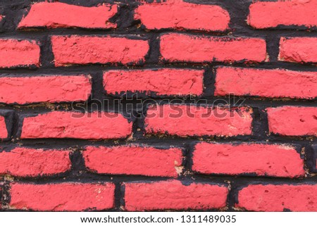 red brick wall with black stripes