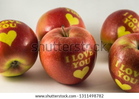 Valentine's days composition. Sweet and lovely red fruits. I love You apples with yellow hearts. 