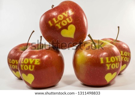 Valentine's days composition. Sweet and lovely red fruits. I love You apples with multiple yellow hearts. 