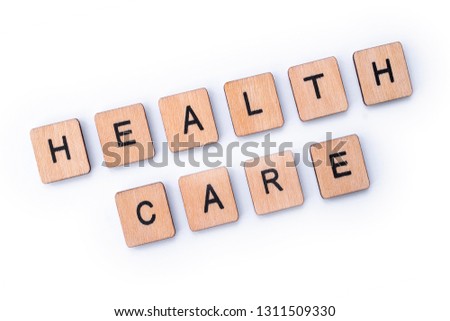 HEALTH CARE, spelt with wooden letter tiles.
