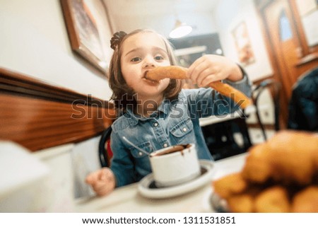 Kid eating chocolate churros