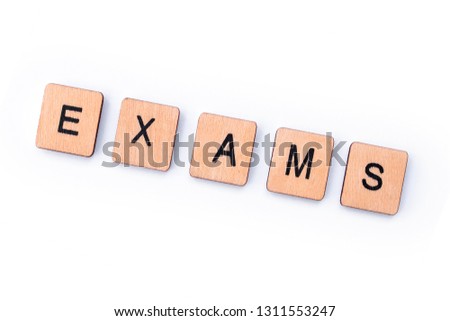 The word EXAMS, spelt with wooden letter tiles.