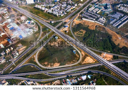  Top view aerial of Long Thanh - Dau Giay expressway at Vo Chi Cong intersection area, District 2, Ho Chi Minh city, Vietnam with development buildings, transportation, energy power infrastructure