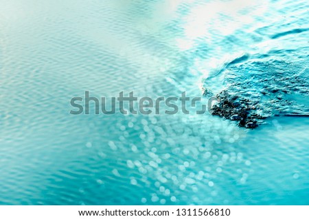 white blue light bokeh on soft clam ripple wave of summer sea water for travel relaxation background