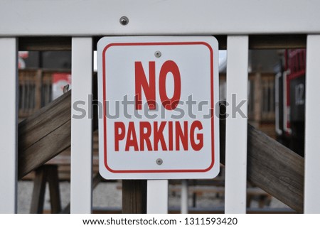 No parking sign in a fence