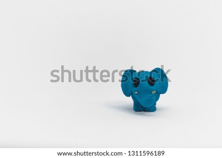 Little cute elephant. Small blue elephant made from plasticine isolated on white background 