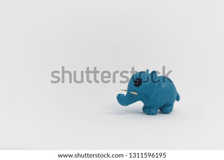 Little cute elephant. Small blue elephant made from plasticine isolated on white background 