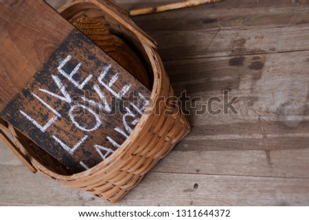 love live laugh text on wood board in basket style warm mood concept. - Image