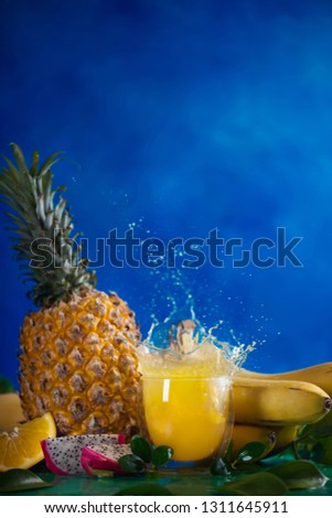 Fresh juice dynamic splash. Tropical fruits, bananas, pineapple, and dragon fruit. Exotic drink action photography with copy space