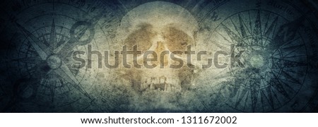 Pirate skull and compasses on old grunge paper background. Retro style. Science, travel, vintage background. History and geography team. Royalty-Free Stock Photo #1311672002