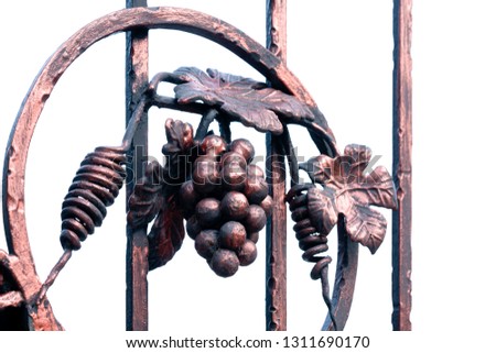 Forged bunch of grapes. ornate wrought-iron elements of metal gate decoration.