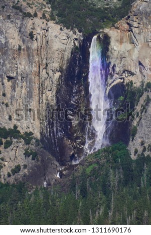 Yosemite fall with a rainbow with it.