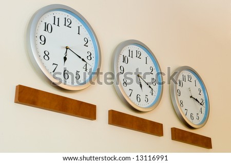 Row of clocks hanging on wall