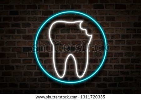Damaged Tooth, Neon sign on the background of the fire wall. The concept of dental clinic, first aid.