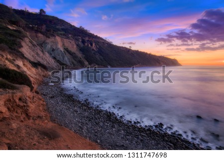 Long exposure photo of Southern California coastline after sunset with dramatic clouds in the sky, Bluff Cove, Palos Verdes Estates, California