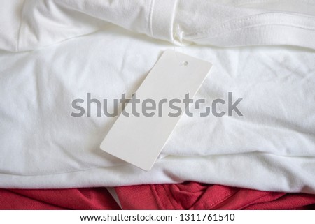 Blank price tag label on white t-shirt