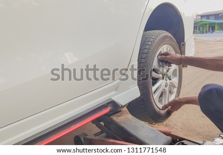 Removing car mechanic to repair the leaky tire car wheels, because of the exposed screw drill.