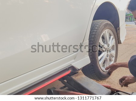 Removing car mechanic to repair the leaky tire car wheels, because of the exposed screw drill.