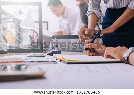 Business meetings of real estate brokers and engineering team to review blueprint  to build a housing estate at office 
 Royalty-Free Stock Photo #1311785486