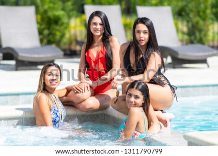 Teenage girls having fun at a pool party in the summer