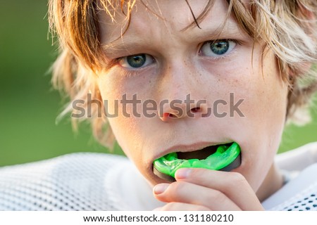 Boy putting in his mouth guard Royalty-Free Stock Photo #131180210