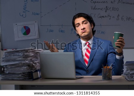 Young elegant financial specialist working in the office night t