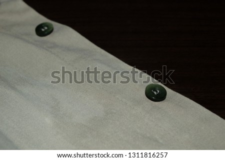 green button on cotton shirt