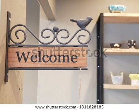 Welcome sign with a little bird