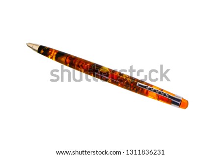 Beautiful ballpoint pen made of amber orange brown. Isolated on white background.