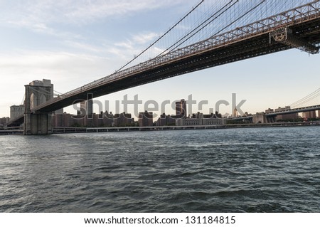 Brooklyn bridge shot from below looking into Manhattan