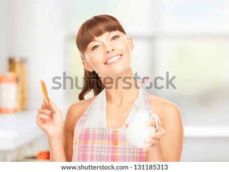 picture of beautiful housewife with milk and cookies